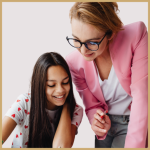 Image of a woman in a pink blazer coaching a young writer